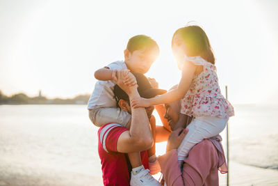 Side view of family against sky