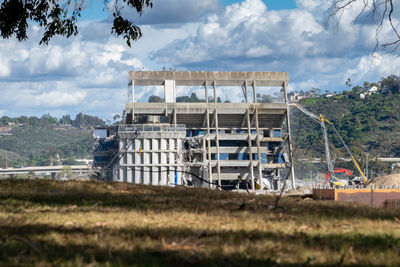 Built structure on field against sky