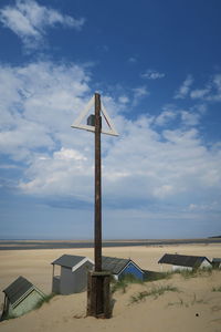 Lifeguard hut on beach against sky