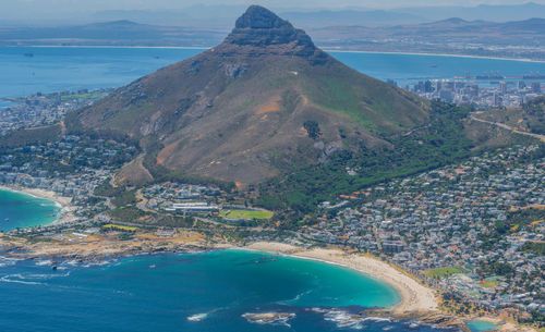 High angle view of sea and mountains against sky