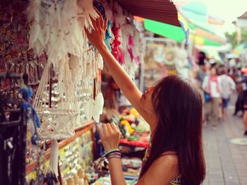 Side view of woman shopping at street market