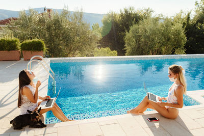 Portrait of woman sitting in swimming pool