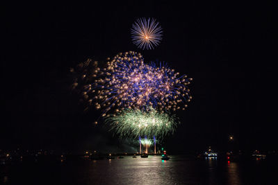 Low angle view of firework display at night