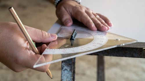 Cropped hands of man working on table