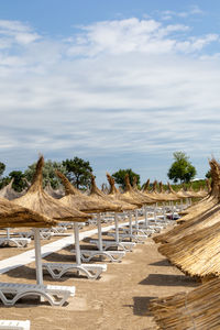 Sunbeds and umbrellas on the sandy beach, the summer season is ready for tourists