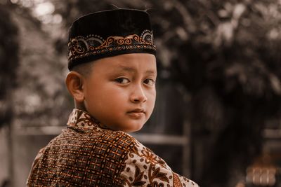 Close-up portrait of boy looking outdoors