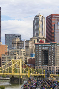 Buildings in city against cloudy sky