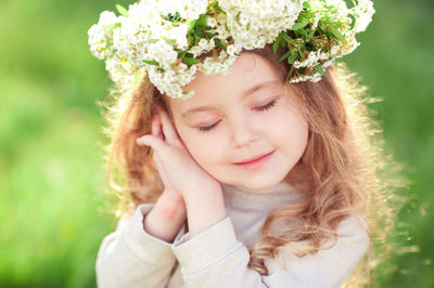 Close-up of girl wearing wreath at park