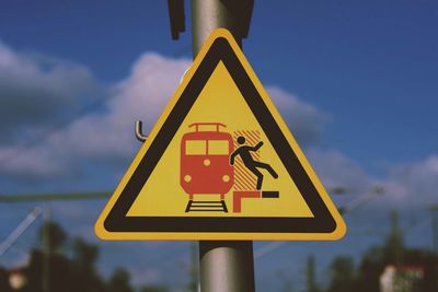 Close-up of railway sign on pole