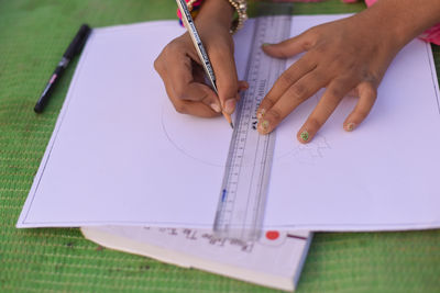 Close-up of hands working on table