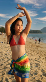 Young woman standing at beach