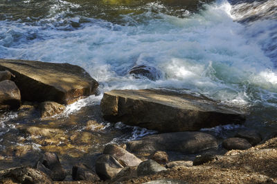 Waves splashing on rocks at shore