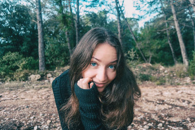 Portrait of beautiful young woman in forest