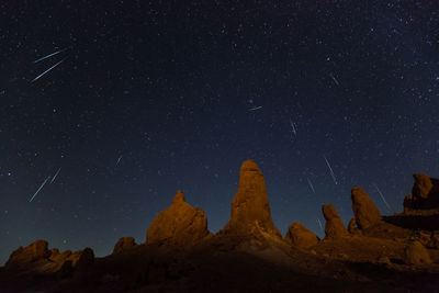 Low angle view of rocks against sky at night