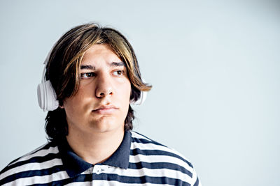 Portrait of young woman against white background