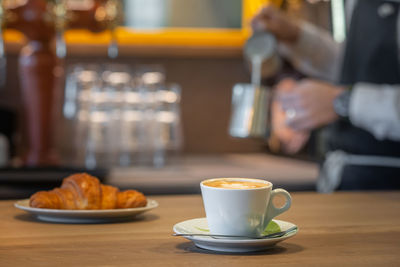 Close-up of coffee served on table at cafe