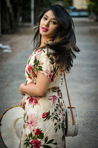 Beautiful young woman standing in traditional clothing