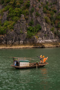 Boat on rock by sea