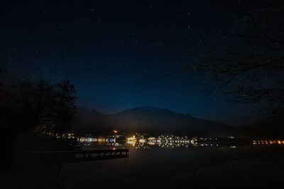 Illuminated city against sky at night