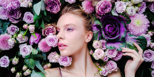 Low angle view of woman with pink roses