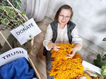 Portrait of smiling young woman sitting on table