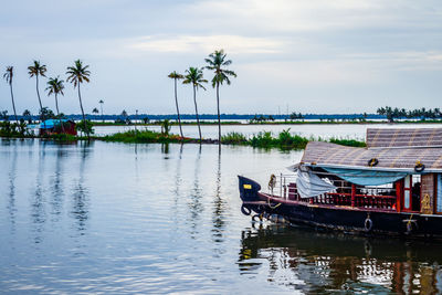 Boats moored in sea against sky