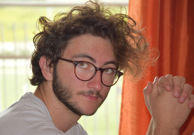 Close-up portrait of young man at home