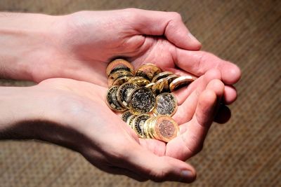 Cropped image of hands holding coins