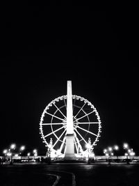 Low angle view of ferris wheel against sky at night