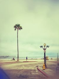 Empty road against cloudy sky