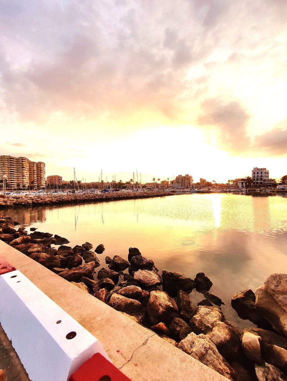 SCENIC VIEW OF RIVER BY CITY AGAINST SKY