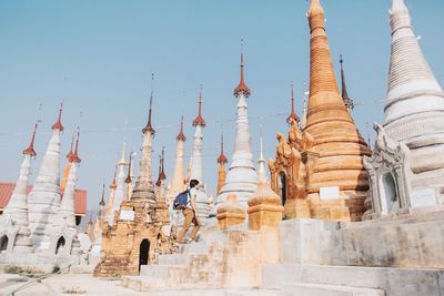 Low angle view of man walking at temple