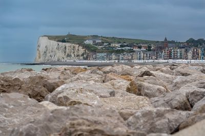 Rocks by sea against sky