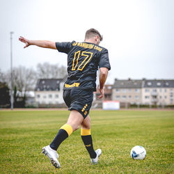 Full length of man playing soccer on field