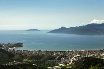 Scenic view of sea and mountains against sky