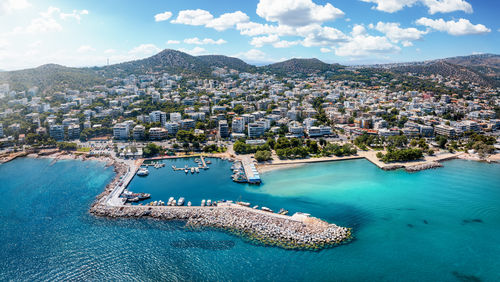 High angle view of townscape by sea against sky