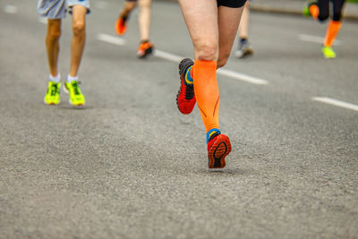 Low section of man running on road