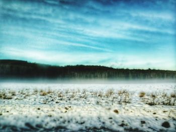 Scenic view of snow covered landscape against sky