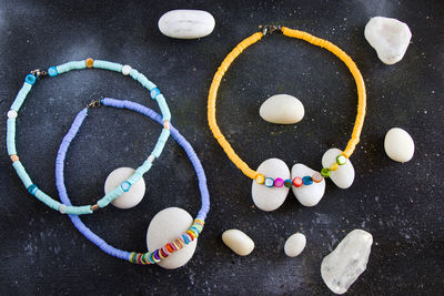 Colorful necklace and bracelet mix, beads and stone necklace, jewelry on the blue background