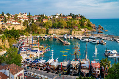 High angle view of townscape by sea against sky