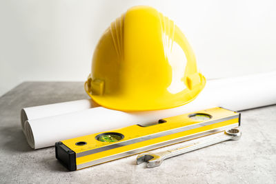 Close-up of yellow container against white background