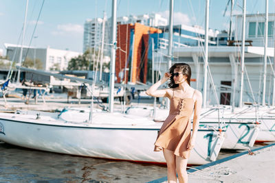 Young woman on sailboat at harbor