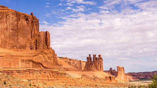 Rock formations against cloudy sky