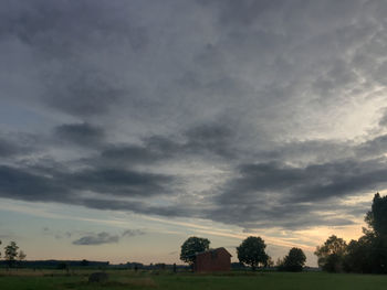 Scenic view of field against sky during sunset