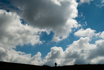 Low angle view of silhouette land against sky