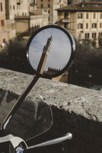 Torre del mangia reflecting on vehicle mirror