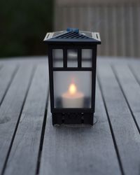 Close-up of illuminated lamp on table