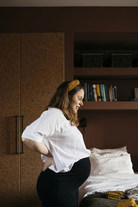 Young woman reading book at home