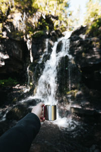 Midsection of person drinking water