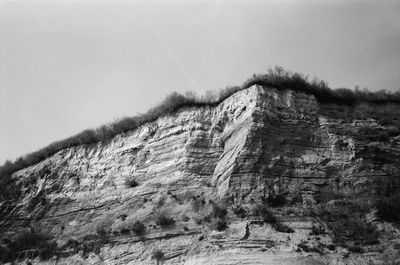 Low angle view of rock formation against clear sky